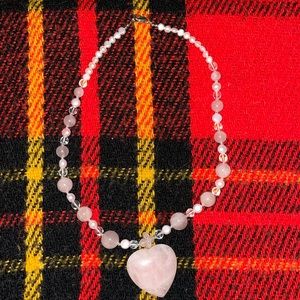 Necklace pink heart solid size 19” long marble type material. It’s beautiful